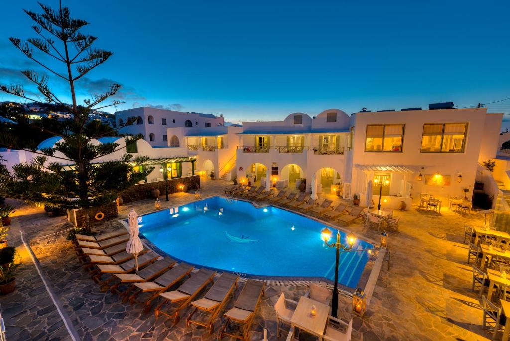 an outdoor pool with chairs and a resort at Hotel Mathios in Akrotiri