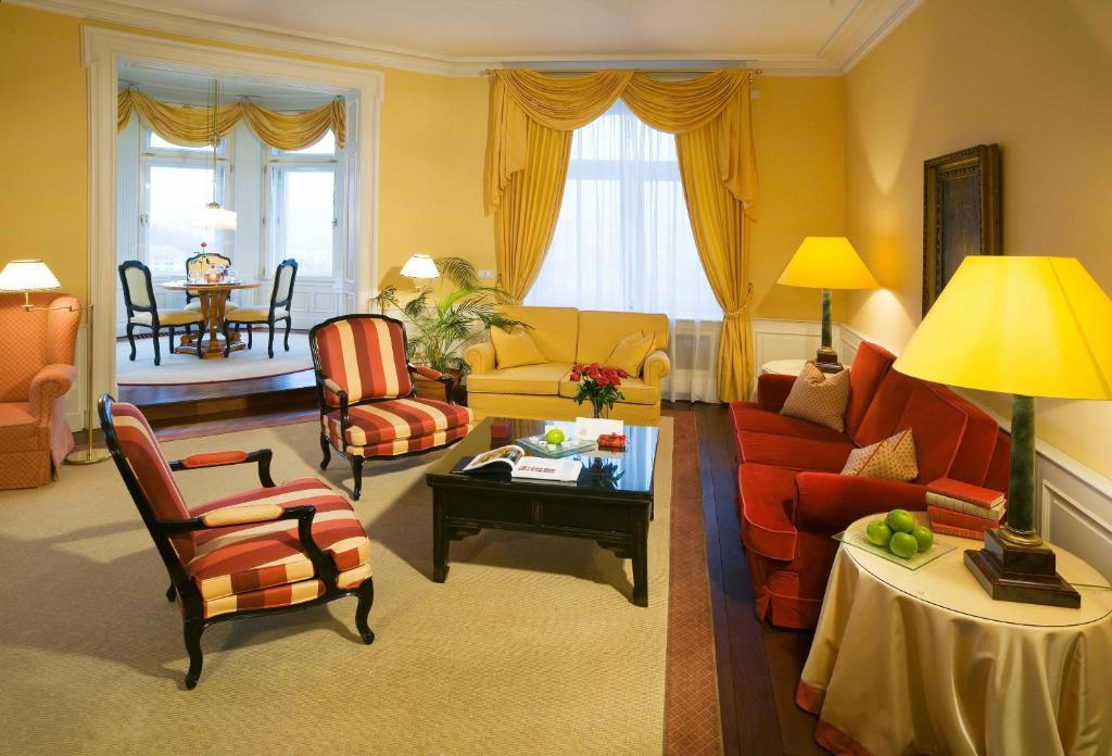 a living room with a couch and chairs and a table at Le Palais Art Hotel Prague in Prague