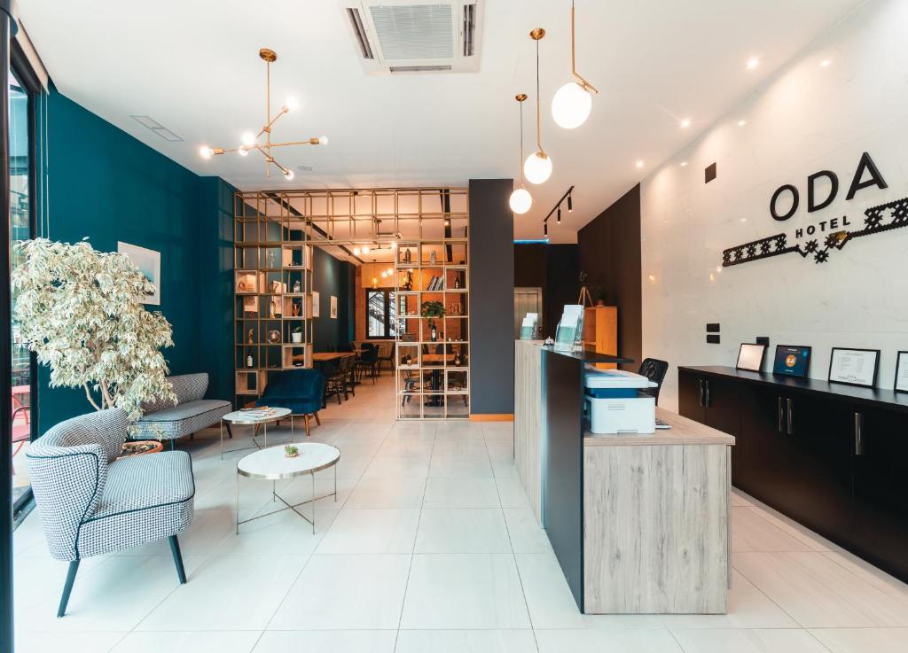 a lobby of an office with chairs and tables at Oda Hotel Tirana in Tirana