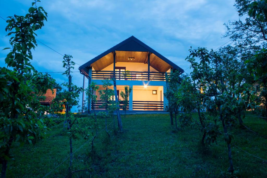 a house with a blue roof in a field at Holiday Home Dandelion with Hot Tub & Sauna in Cetingrad