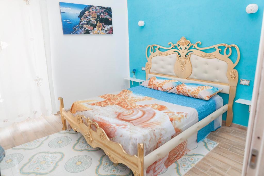 a bedroom with a bed in a room with blue walls at Bed & Breakfast Santa Caterina in Ercolano