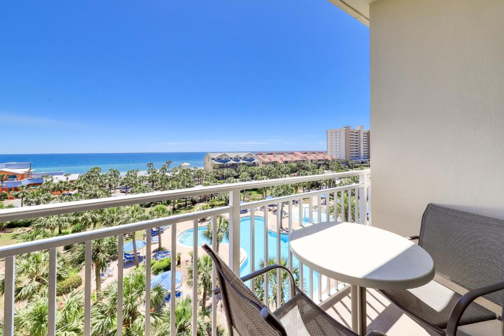 a balcony with a table and chairs and the ocean at Sterling Shores 510 Destin (Condo) in Destin
