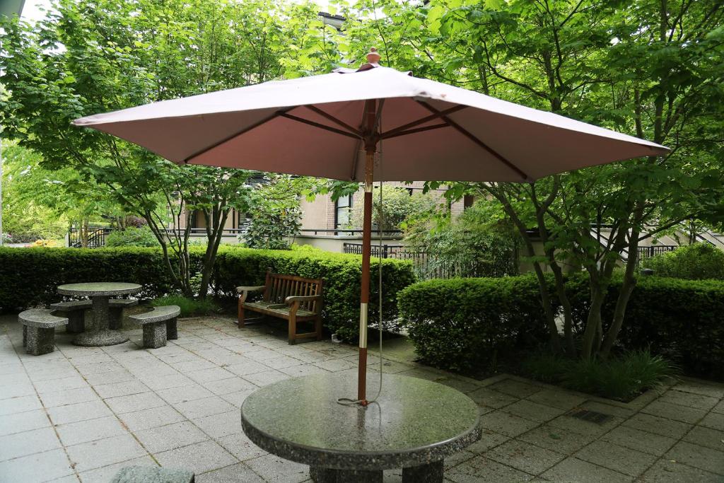 a table with an umbrella on a patio at Carey Centre on UBC campus in Vancouver