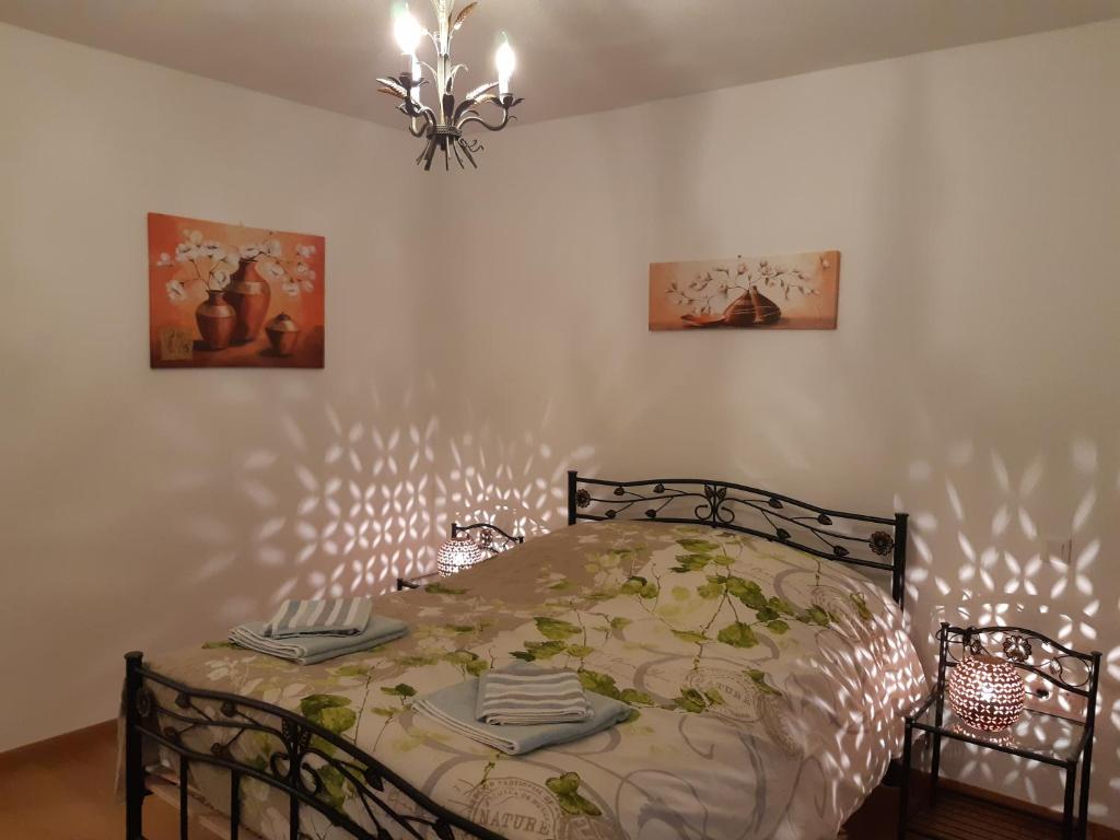 a bedroom with a bed and two pictures on the wall at Le Carré Confidentiel in Strasbourg