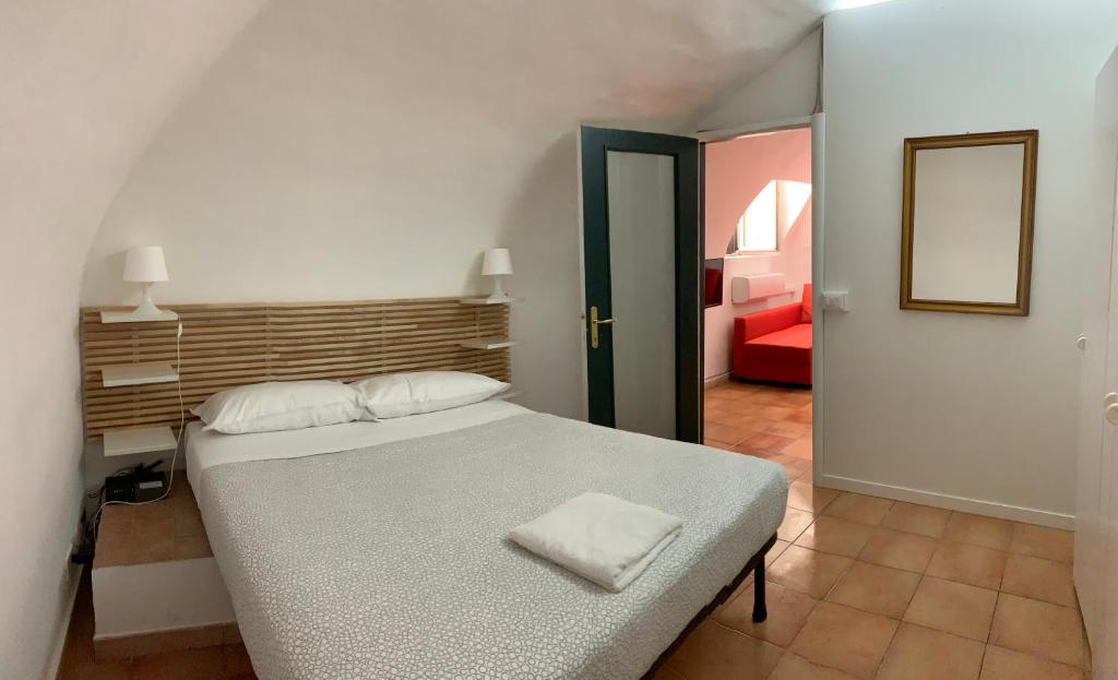 a bedroom with a bed and a red couch at Le Tartarughe Boutique Apartment in Rome