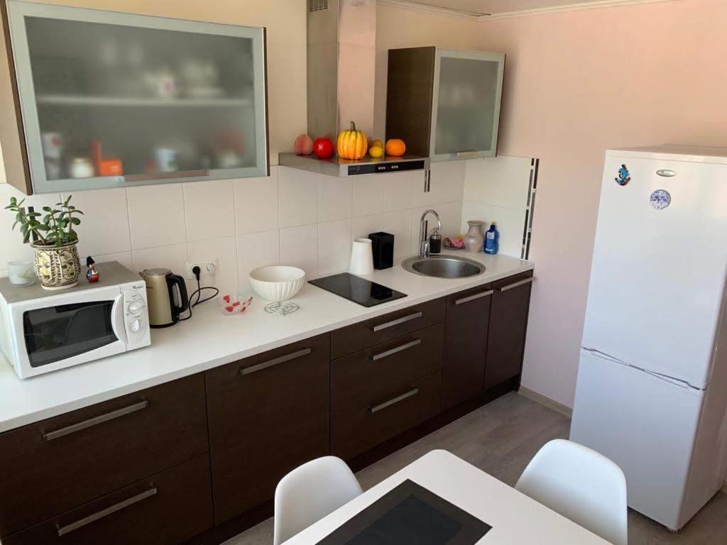 a kitchen with a sink and a white refrigerator at Baltic Dreams 2 in Jūrmala