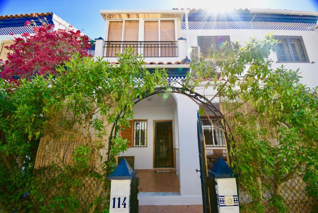 an entrance to a white house with an archway at 38 Fantastic Holiday // AC - WIFI in La Mata