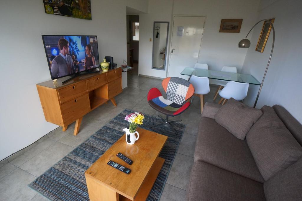 a living room with a couch and a tv at Ático Palermo in Buenos Aires