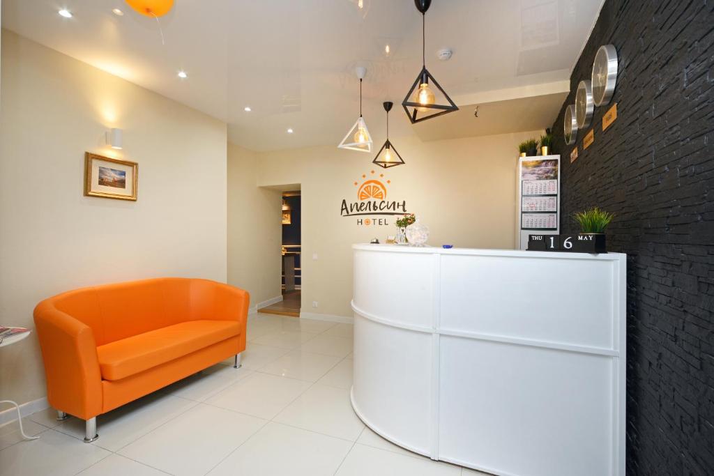 an office with an orange chair and a counter at Hotel Orange Expo in Moscow