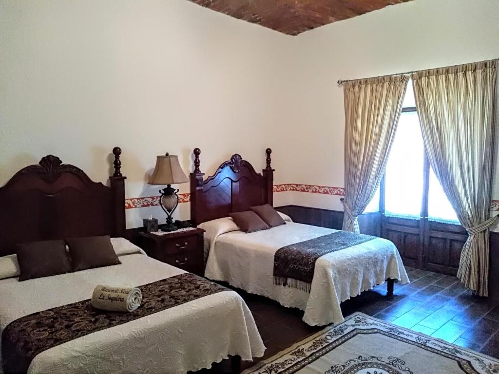 Postel nebo postele na pokoji v ubytování Hotel Spa Hacienda Real la Nogalera