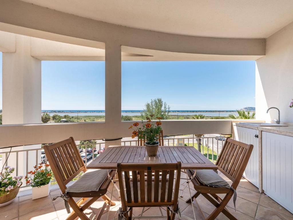 d'une table et de chaises sur un balcon avec vue sur l'océan. dans l'établissement Panorama Fantastico sul golfo degli angeli, à Su Forti