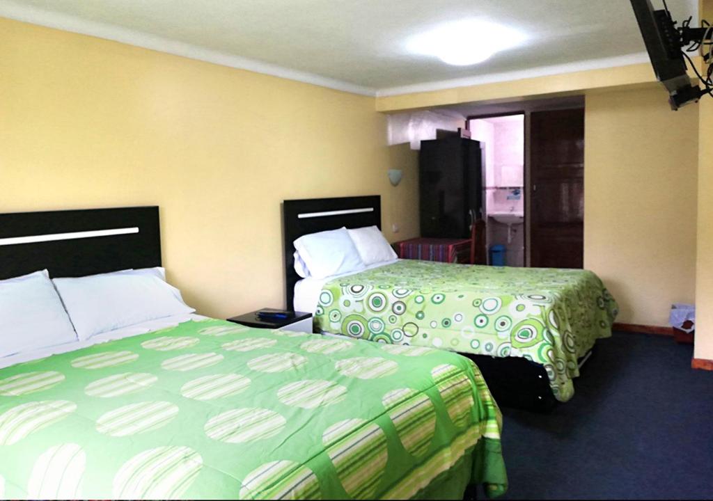 Postel nebo postele na pokoji v ubytování Hostal Lucerito