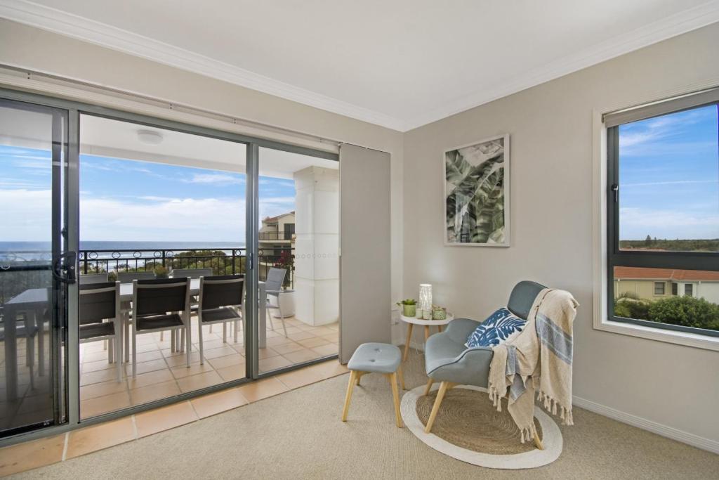 a living room with a view of a balcony at Breakers 2 12 - LJHooker Yamba in Yamba