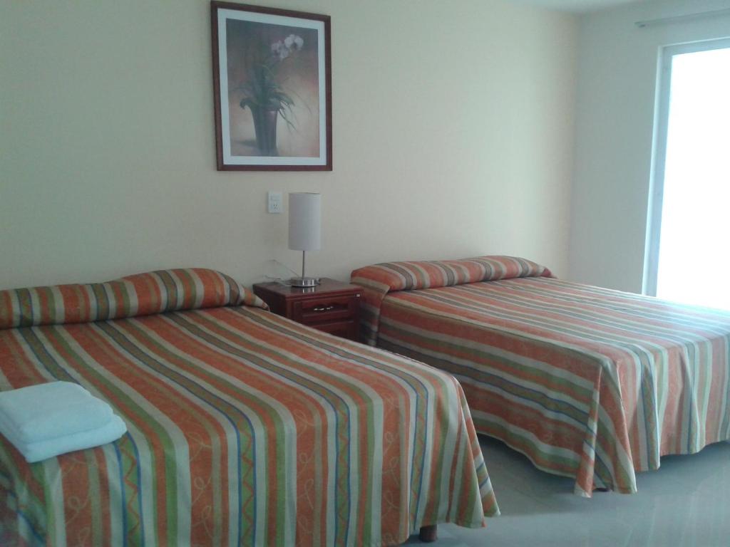 Postel nebo postele na pokoji v ubytování Hotel Playa Azul