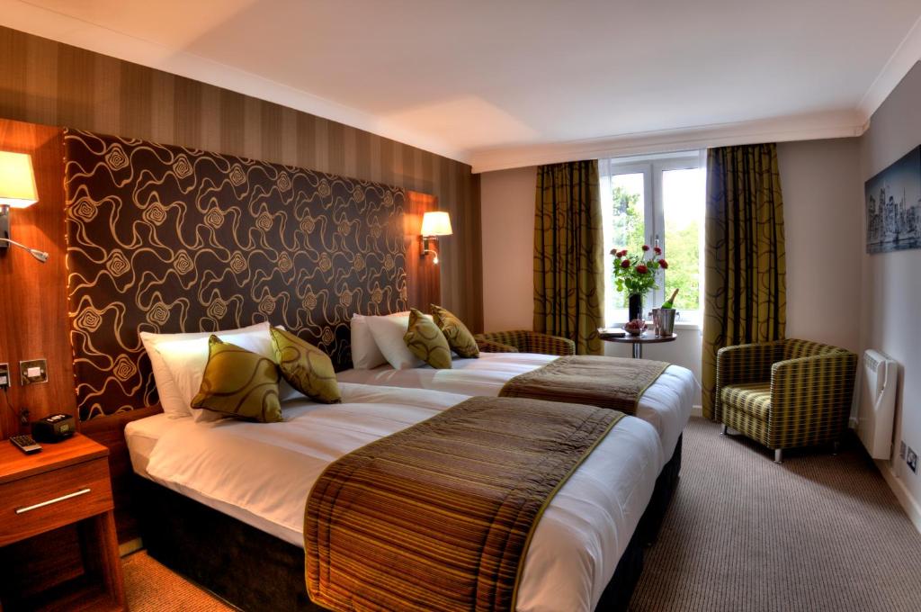 
A bed or beds in a room at The Collection Hotel Birmingham
