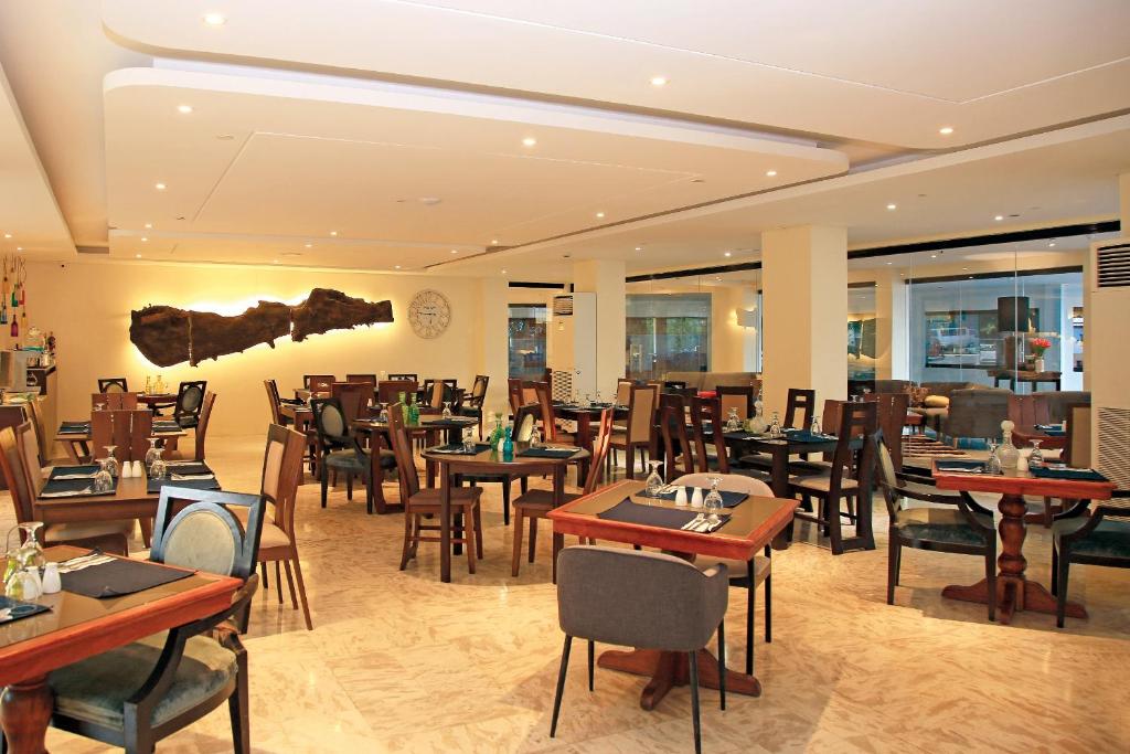 a restaurant with tables and chairs in a room at PROXY by The Oriental Albay in Legazpi