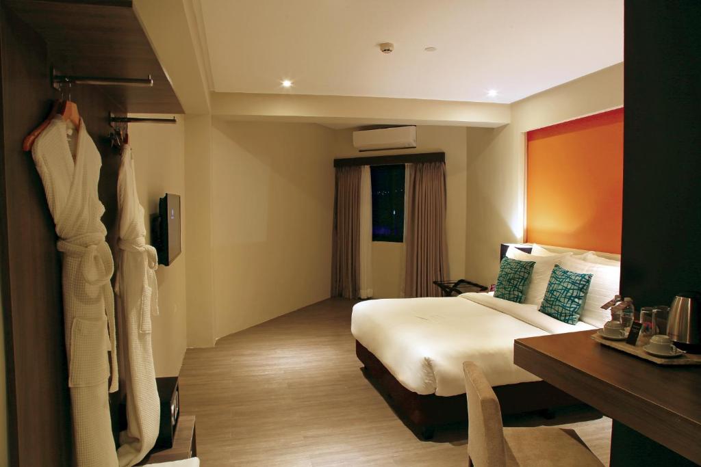 a hotel room with a bed and a desk at PROXY by The Oriental Albay in Legazpi
