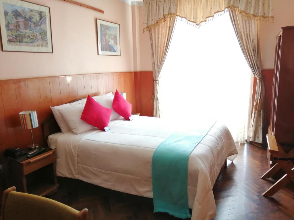 Postel nebo postele na pokoji v ubytování Huaytusive Inn Hotel