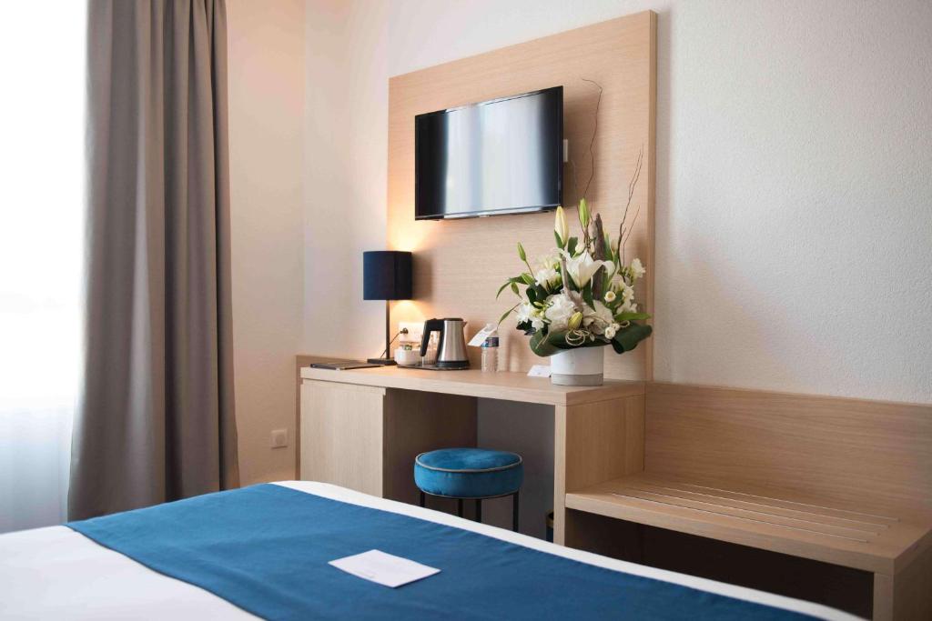Postel nebo postele na pokoji v ubytování Best Western Hôtel Le Sud