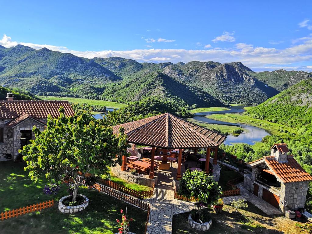 an aerial view of a house with a river and mountains at Rooms Dujeva Drago-Resort in Rijeka Crnojevića