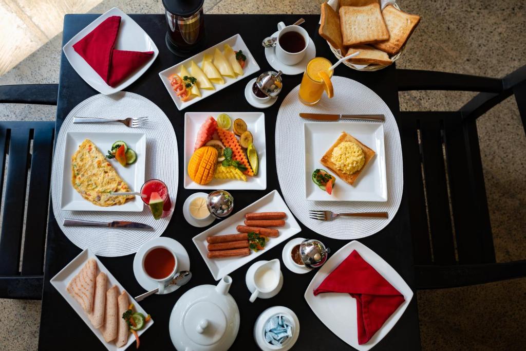 a table with plates of food on a table at Amal Beach Hotel in Bentota