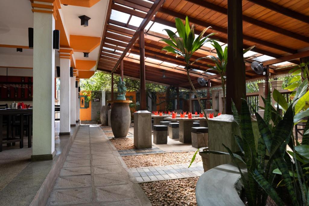 a patio with tables and chairs in a restaurant at Amal Beach Hotel in Bentota
