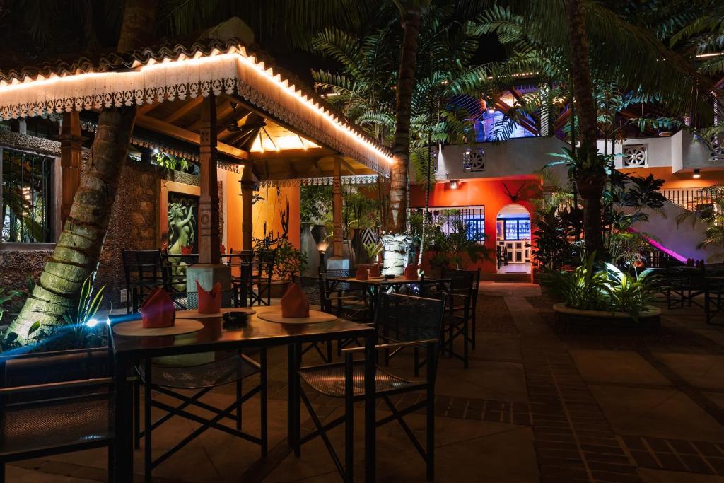 a restaurant with tables and chairs at night at Amal Beach Hotel in Bentota