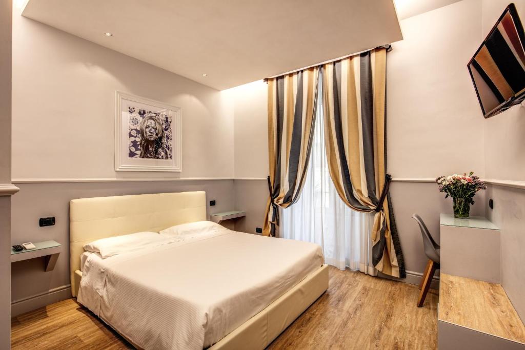 a small bedroom with a bed and a window at Hotel Taormina in Rome