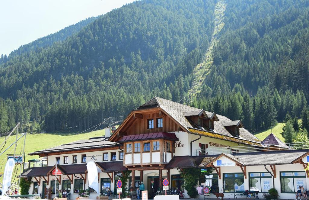 a large building with a mountain in the background at Appartement Schizentrum Grosseck - Speiereck in Mauterndorf