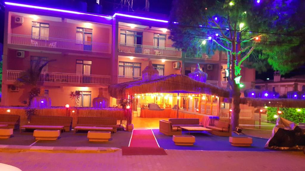 a hotel with purple lights in front of a building at Grand Yayla Hotel in Cesme