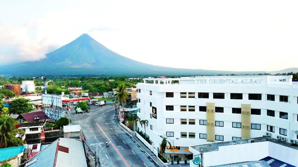 a view of a city with a mountain in the background at PROXY by The Oriental Albay in Legazpi