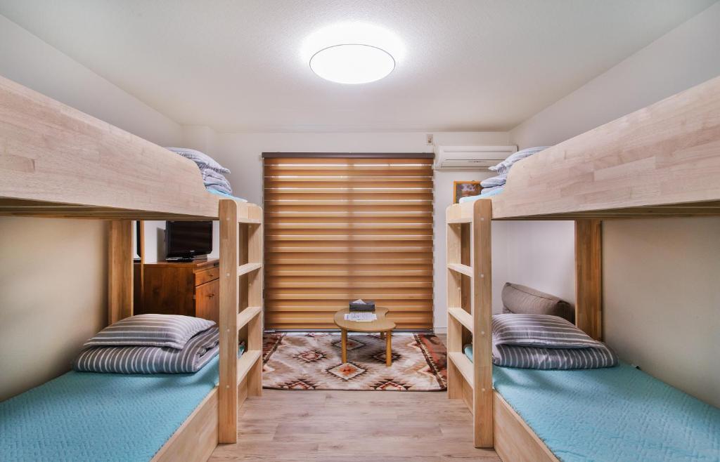 two bunk beds in a small room at River Forest in Osaka