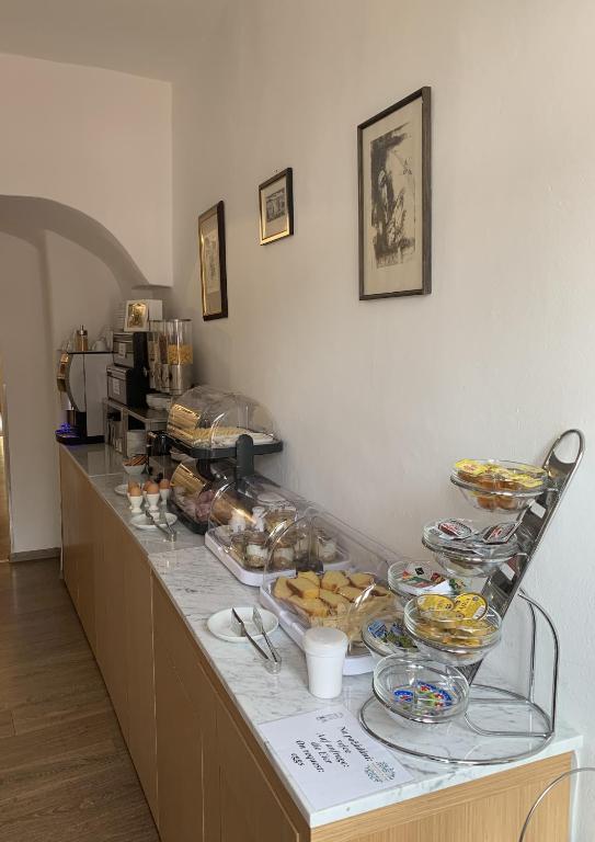 a buffet with bowls of food on a counter at Hotel 100 in Pardubice