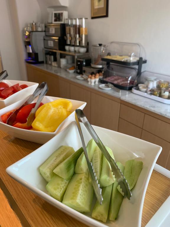 a plate of fruit on a table in a kitchen at Hotel 100 in Pardubice