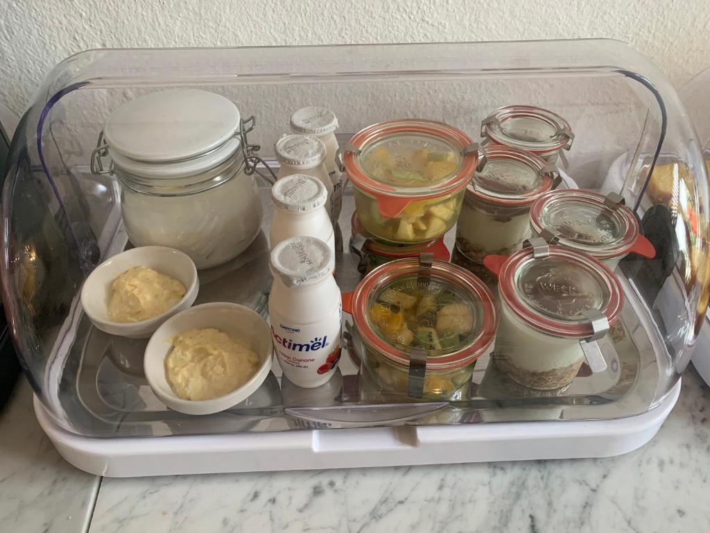 a refrigerator filled with jars and other food items at Hotel 100 in Pardubice