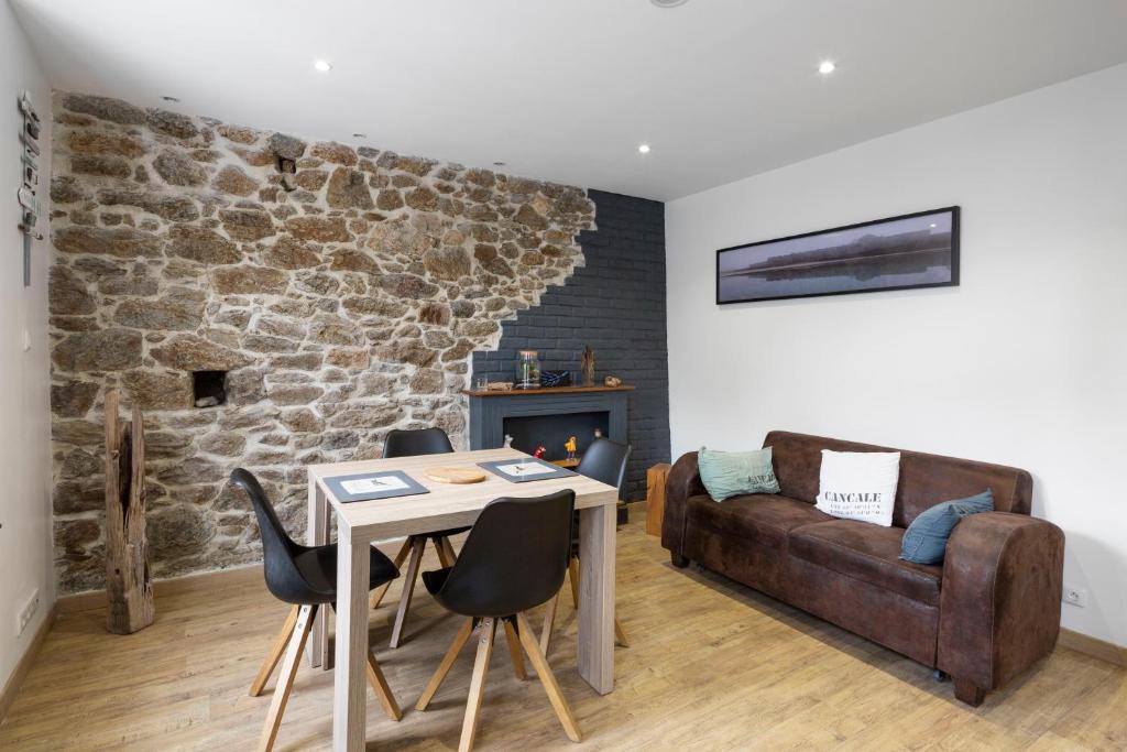 a living room with a table and a couch at Les Bois Flottés in Saint Malo