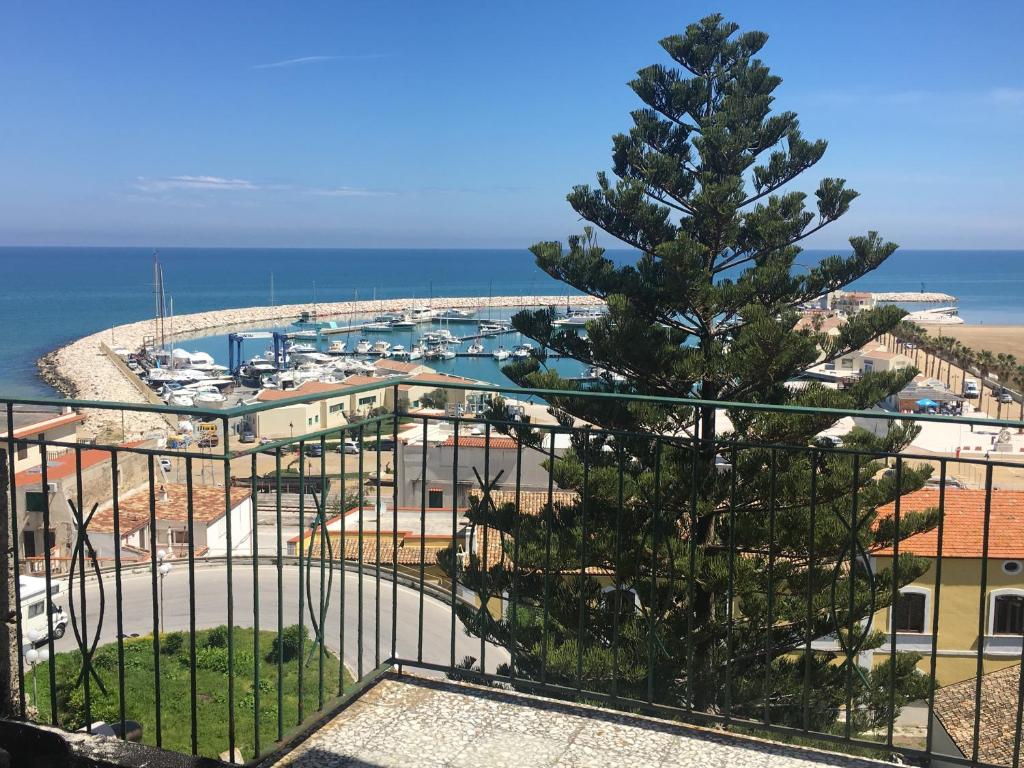 a view of a marina with a pine tree at Residence Ducale in Rodi Garganico