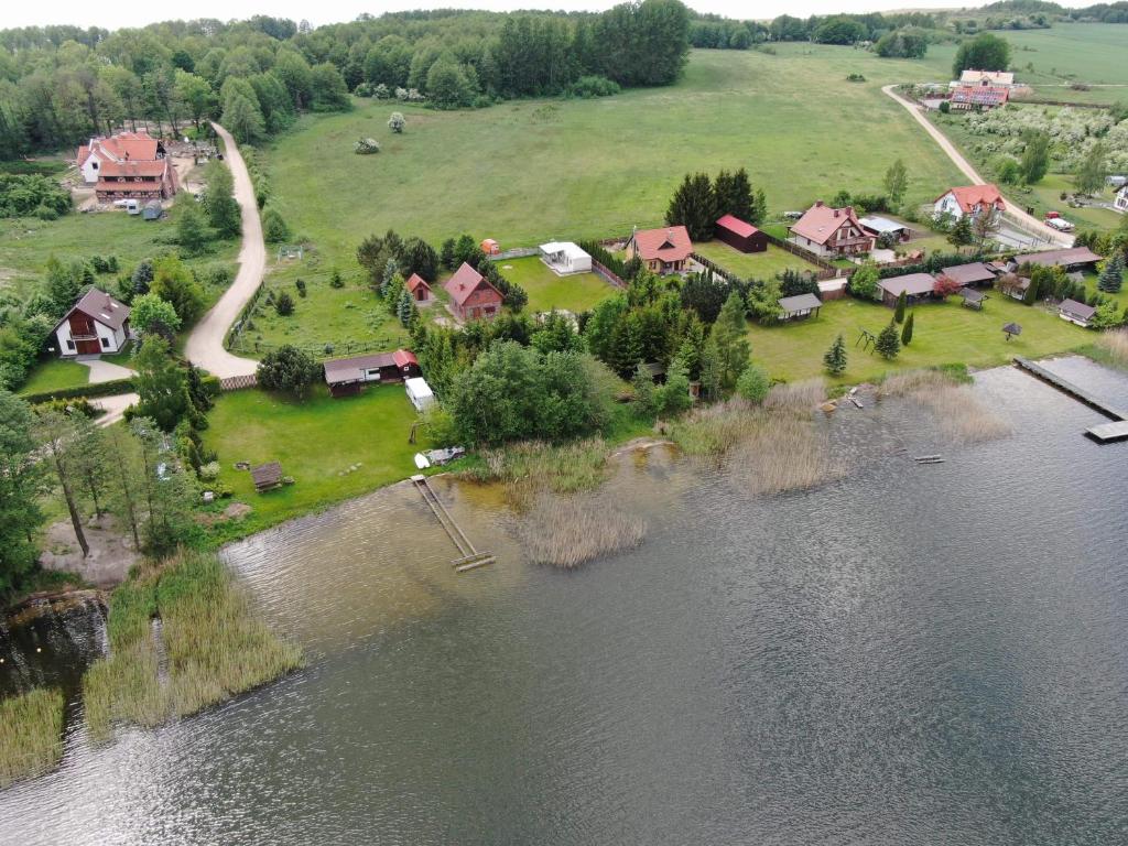 an aerial view of a house next to a river at Domek na półwyspie Kal in Węgorzewo