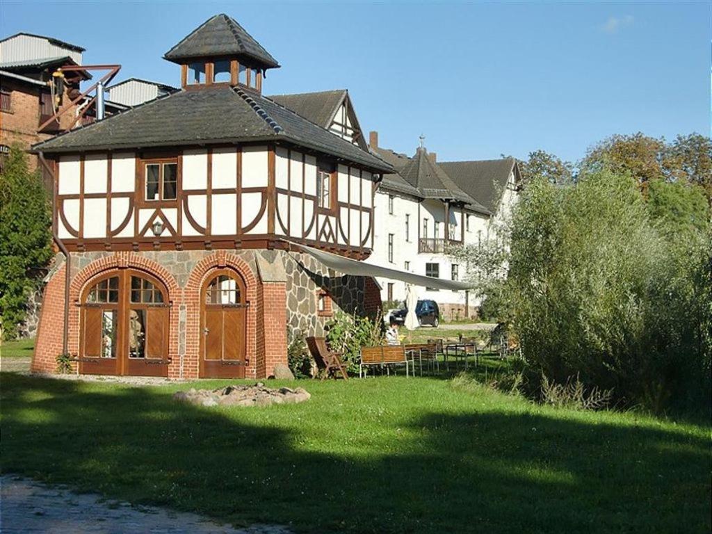 una gran casa de ladrillo con una torre de reloj en la parte superior en Ferienwohnung A3 en Klocksin