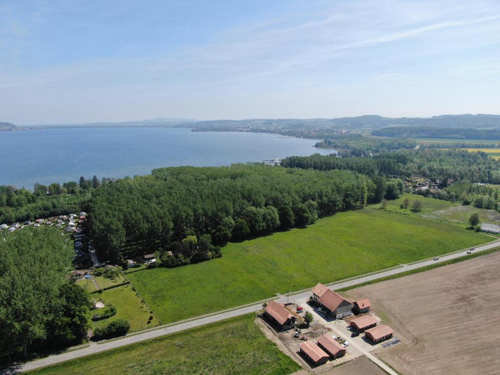 una vista aérea de una casa junto a un lago en Les Moucherons en Avenches