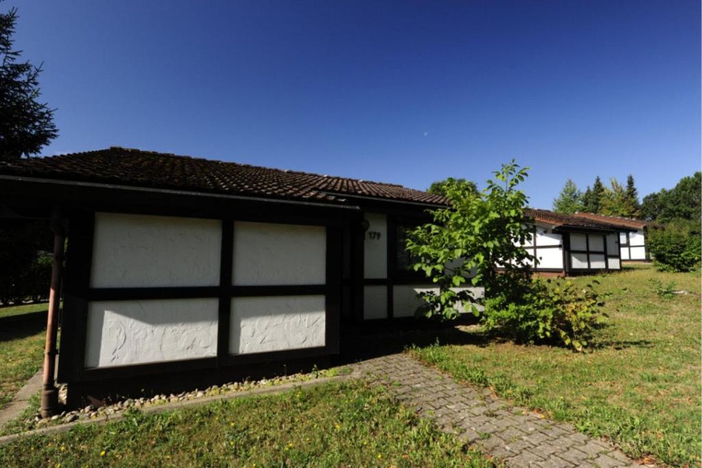 a building with two garage doors in a yard at Holiday park- Scout in Waldbrunn