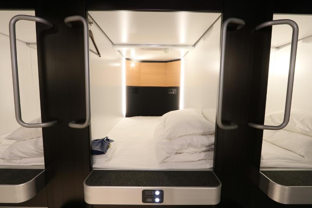 Postel nebo postele na pokoji v ubytování Business Capsule Hotel Lightning Hotel Asakusa