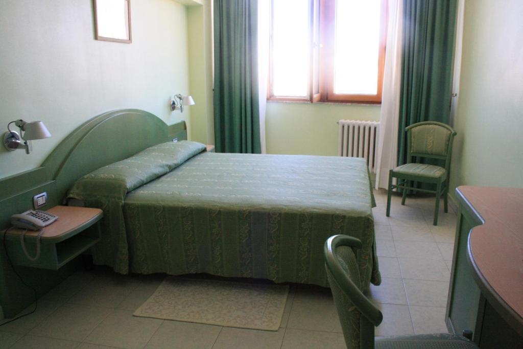 Postel nebo postele na pokoji v ubytování Hotel Grillo