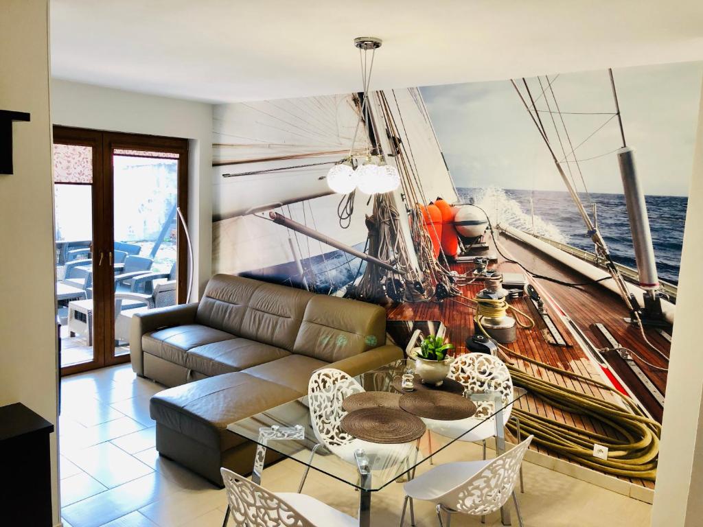 a living room with a large painting of a boat at Willa Stornia in Jastarnia