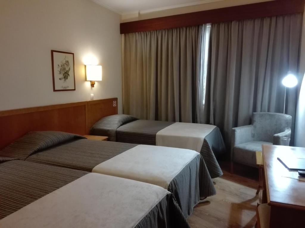Postel nebo postele na pokoji v ubytování Hotel Do Centro