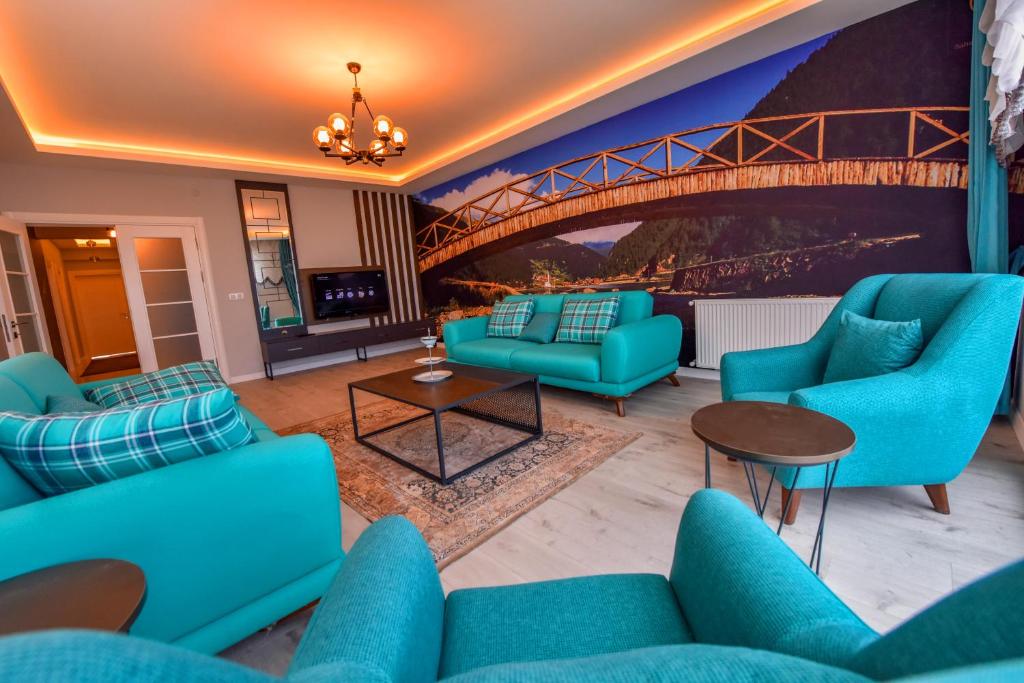 a living room with blue couches and a bridge at BAHAR RESIDENCE in Trabzon