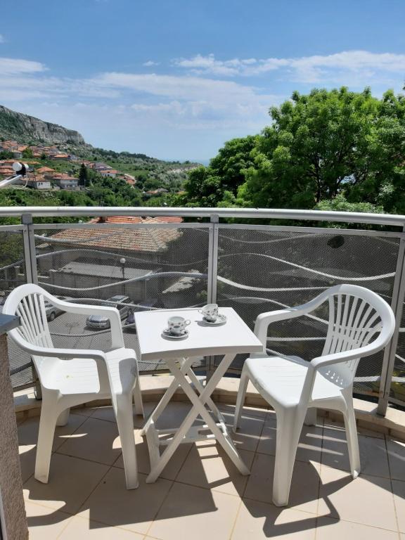 a white table and two chairs on a balcony at Апартамент "Амира" in Balchik