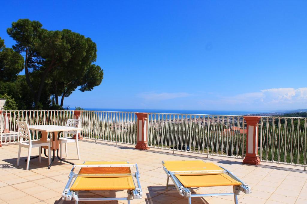 a patio with two chairs and a table and chairs at Il Parco Sul Mare Resort & SPA in Tortoreto Lido