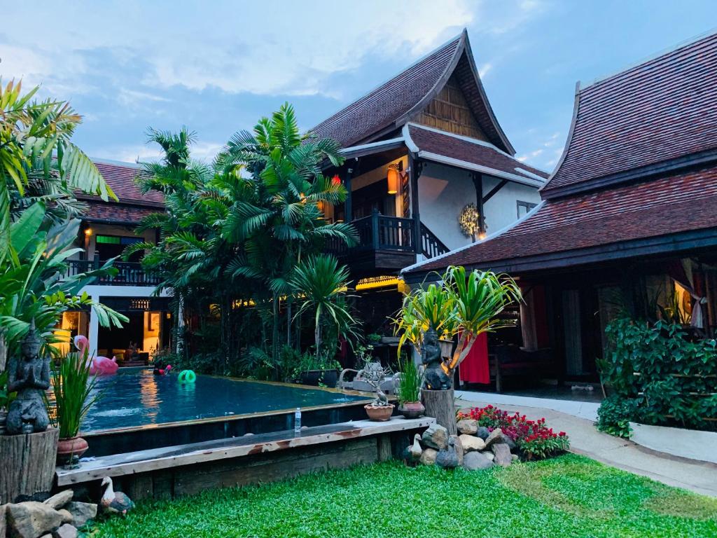 A garden pool courtyard surrounded by traditional Thai-style buildings.