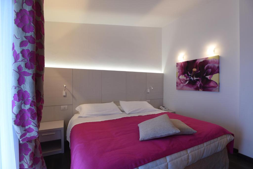 Posteľ alebo postele v izbe v ubytovaní Hotel La Vigna